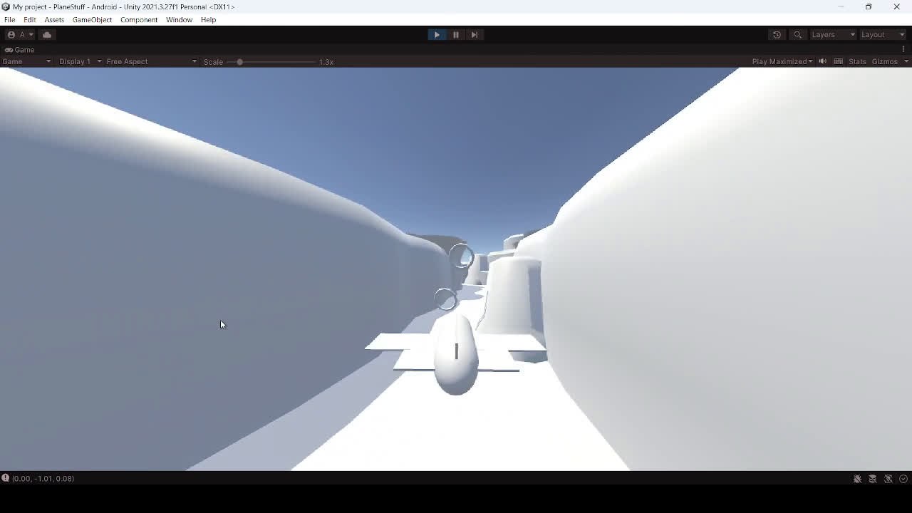 An early greybox build of Canyon Racer running in Unity, a plane flying through a plain white canyon.